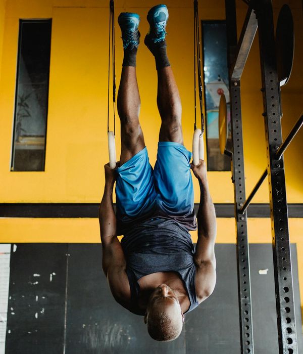 Man performing a controlled strength exercise in a minimalist gym setting.